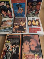 Group shot of seven VHS tapes, covers visible