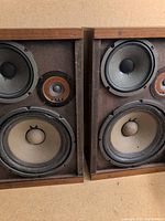 Front view of both speakers showing drivers and cabinet finish
