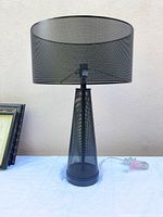 Full view of lamp showing mesh shade, base, and cord
