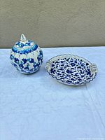 Overall view of handled dish and lidded jar