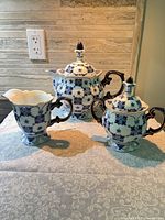Front view of all three porcelain pieces displaying matching blue floral design