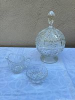 Group view of compote with lid, creamer, bowl