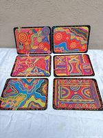 Front view of all six placemats displaying unique Aboriginal art designs