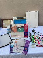 Overall lot on table showing folders, labels, markers, clips and accessories