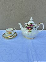 Full view of Royal Albert teapot with lid, Staffordshire teacup and saucer on cloth
