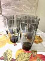 All six smoke grey glass tumblers on table
