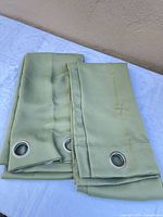 Both folded curtain panels showing grommet tops