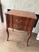 Front view showing drawers, hardware, legs and overall form