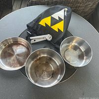 Full cook set with two pots, pan-lid, pot gripper and storage sack laid out