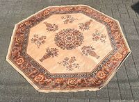 Full view of octagonal wool rug on pavement