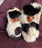 Front view of both rabbit fur-clad figures