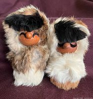 Front view of both wood and fur figures showing faces and fur detail