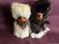 Front view of both wood and fur figures