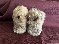 Front view of both fur-covered owl figures