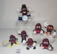 Group shot showing all six California Raisin figures on clear risers