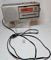 Front view showing LED display, speaker grille, tuning scale, and power cord