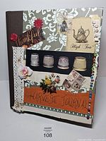 Front cover showing mixed media decorations and harvest journal title