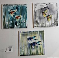 front view of three painted fish tiles