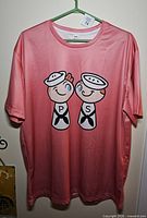 Front of pink T-shirt with Holt Howard sailor S&P graphic
