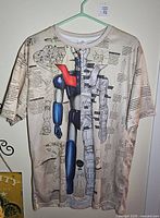 Front of shirt showing robot graphic and blueprint background