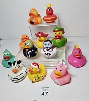 Full lot of thirteen themed rubber ducks front view