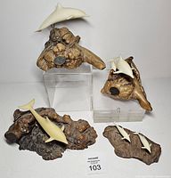 Front view showing all four John Perry dolphin sculptures together