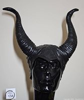 Front view of black rubber Maleficent horns headpiece on mannequin