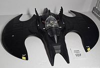 Top view of Batplane with Batman seated in cockpit
