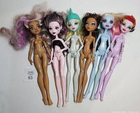 Front view of six nude Monster High dolls standing side by side