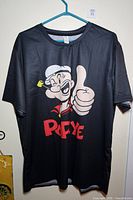 Front view of Popeye graphic T-shirt on hanger