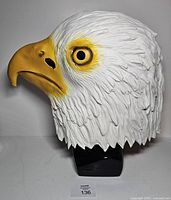 Side profile of rubber eagle mask on stand