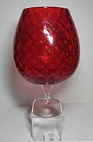 Front view of ruby red Empoli brandy snifter showing full shape