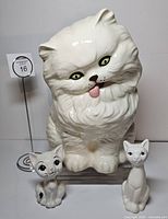Front view of three ceramic cat figurines
