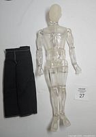 Figure and separate pants laid flat for size and component visibility