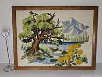 Front view of framed crewel embroidery showing full landscape scene
