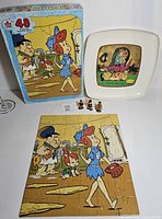 Overall lot showing platter, puzzle box, assembled puzzle, three figurines