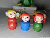 Close-up of three Little People figures