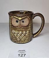Front view showing owl relief and overall glaze