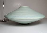 Side profile of pale green low-profile disc ceramic vase