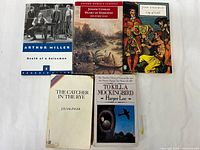 Group shot of the five paperback books in lot