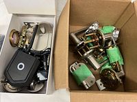 Both boxes showing Kevo lock components and separate box of assorted door handles