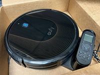 Top view of Eufy RoboVac 30C with charging base and remote