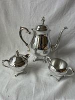 Full view of three silver-plated pieces