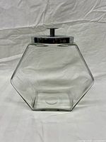 Front view of hexagonal glass jar with metal lid