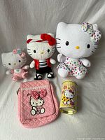 Full lot: three plush dolls, pink quilted bag, cylindrical tin