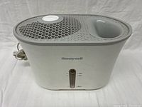 Front view showing brand logo, water-level window, power cord