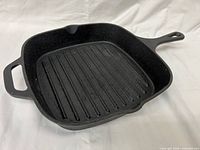 Top view showing square ridged cooking surface, helper handle and long handle