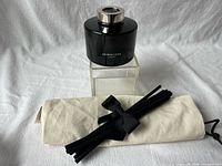 Diffuser bottle with reed bundle and pouch