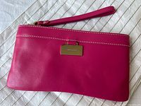 Front view showing color, logo plaque, strap, stitching