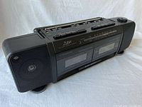 Angled view of entire boombox showing speakers, handle and cassette section